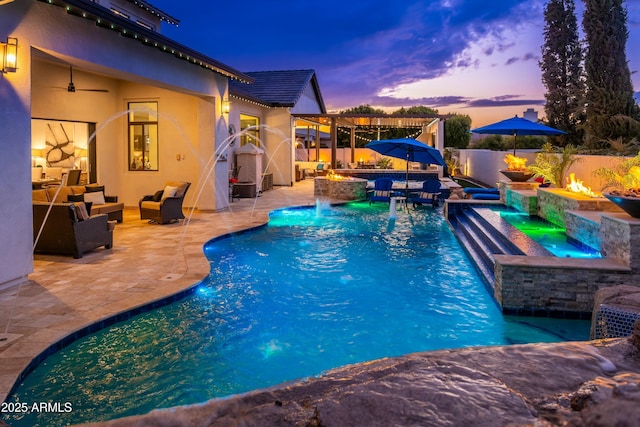 2656 E Oriole Dr, Gilbert, AZ 85297 - pool at dusk featuring a patio, an outdoor living space with a fire pit, an in ground hot tub, and pool water feature