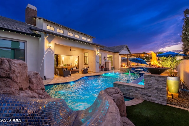 2656 E Oriole Dr, Gilbert, AZ 85297 - pool at dusk featuring outdoor lounge area, an outdoor hot tub, pool water feature, ceiling fan, and a patio