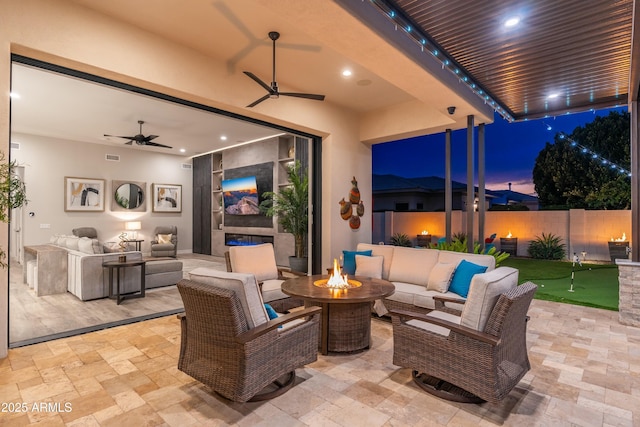 2656 E Oriole Dr, Gilbert, AZ 85297 - patio terrace at dusk with an outdoor living space with a fire pit and ceiling fan