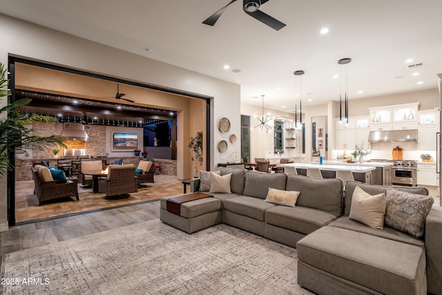 2656 E Oriole Dr, Gilbert, AZ 85297 - living room featuring ceiling fan with notable chandelier and light hardwood / wood-style flooring