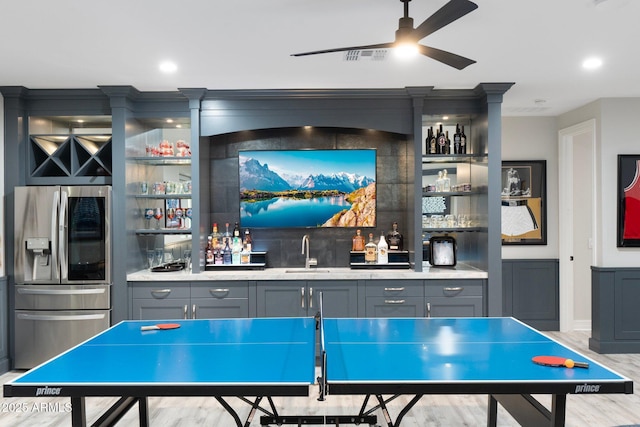 2656 E Oriole Dr, Gilbert, AZ 85297 - game room featuring indoor wet bar, ceiling fan, and light hardwood / wood-style floors