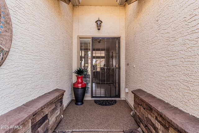 property entrance featuring stucco siding