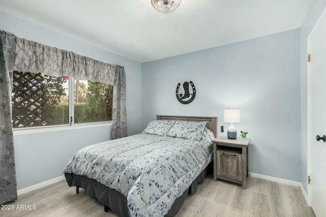 bedroom featuring light wood-style flooring and baseboards