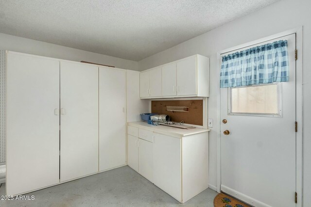 laundry room featuring a textured ceiling