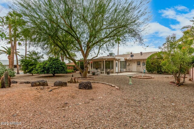 rear view of property with a patio and stucco siding