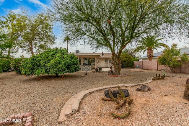 back of property featuring fence and a patio