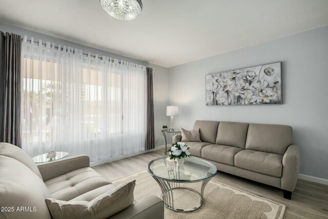 living area featuring baseboards and wood finished floors