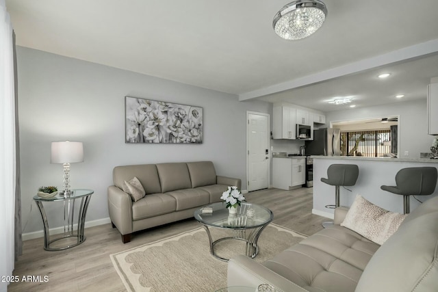 living room with ceiling fan, light wood-style flooring, recessed lighting, baseboards, and beam ceiling