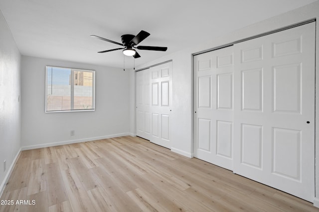 635 N 67th Pl, Mesa, AZ 85205 - unfurnished bedroom with two closets, light wood finished floors, baseboards, and a ceiling fan