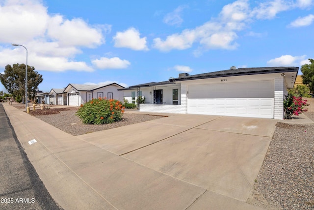 635 N 67th Pl, Mesa, AZ 85205 - single story home featuring a garage, concrete driveway, and a residential view