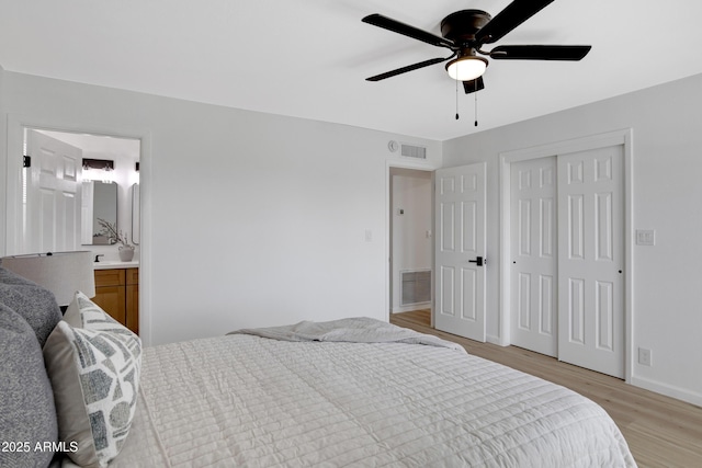 635 N 67th Pl, Mesa, AZ 85205 - bedroom featuring light wood-type flooring, baseboards, ensuite bathroom, ceiling fan, and a closet