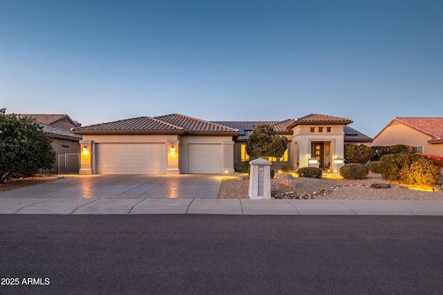 mediterranean / spanish-style home with a garage