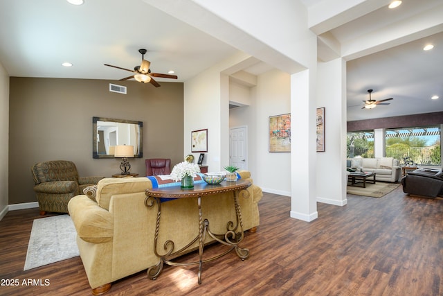 living room featuring vaulted ceiling, ceiling fan, and dark hardwood / wood-style flooring