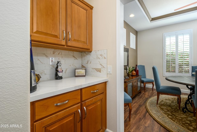 kitchen with dark hardwood / wood-style flooring and decorative backsplash