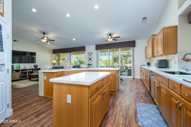 kitchen with vaulted ceiling, a center island, sink, and dark hardwood / wood-style flooring