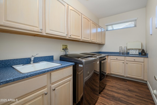 laundry room with cabinets, washing machine and dryer, sink, and dark hardwood / wood-style flooring