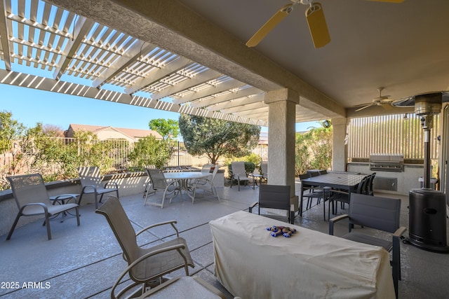 view of patio / terrace with an outdoor kitchen, ceiling fan, grilling area, and a pergola