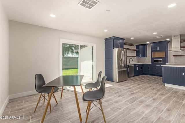 dining room featuring wood finish floors, visible vents, baseboards, and recessed lighting