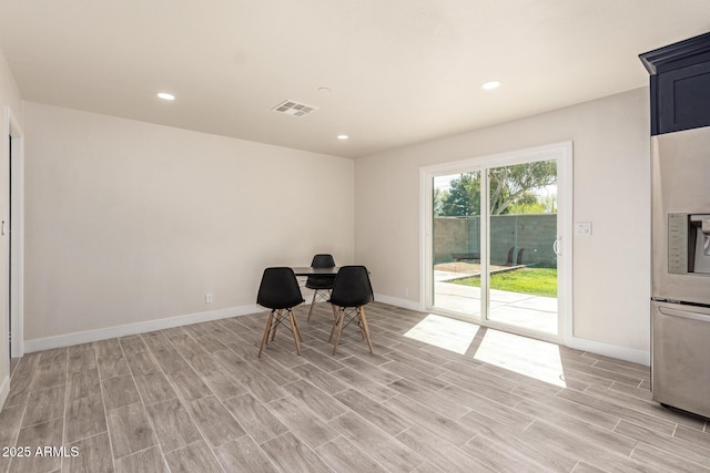 unfurnished room with wood finish floors, visible vents, baseboards, and recessed lighting