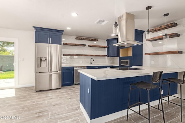 kitchen featuring island range hood, appliances with stainless steel finishes, blue cabinetry, open shelves, and tasteful backsplash