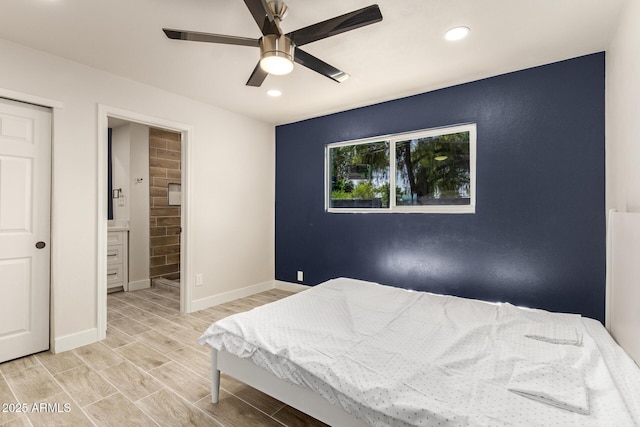 bedroom with baseboards, recessed lighting, ensuite bath, and wood tiled floor