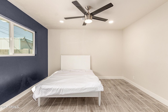 bedroom with wood finish floors, recessed lighting, a ceiling fan, and baseboards