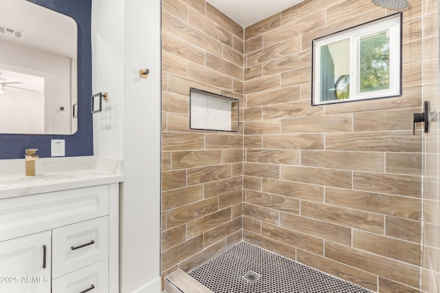 bathroom with a stall shower, visible vents, and vanity