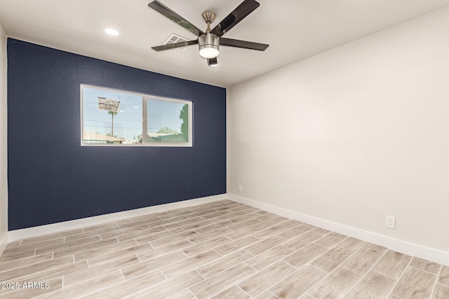 empty room featuring baseboards, a ceiling fan, and wood finish floors