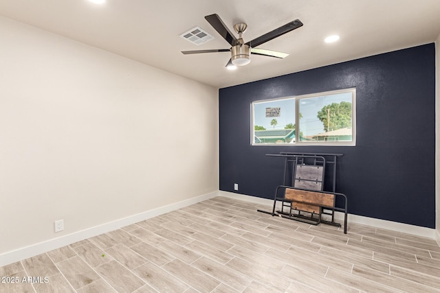 unfurnished room with ceiling fan, recessed lighting, wood finish floors, visible vents, and baseboards