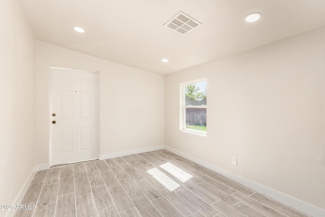 unfurnished room with recessed lighting, visible vents, and light wood-style floors