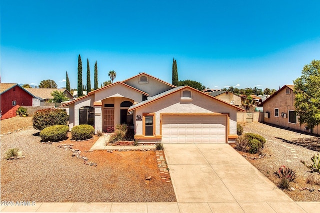 view of front of property featuring a garage, stucco siding, fence, and concrete driveway