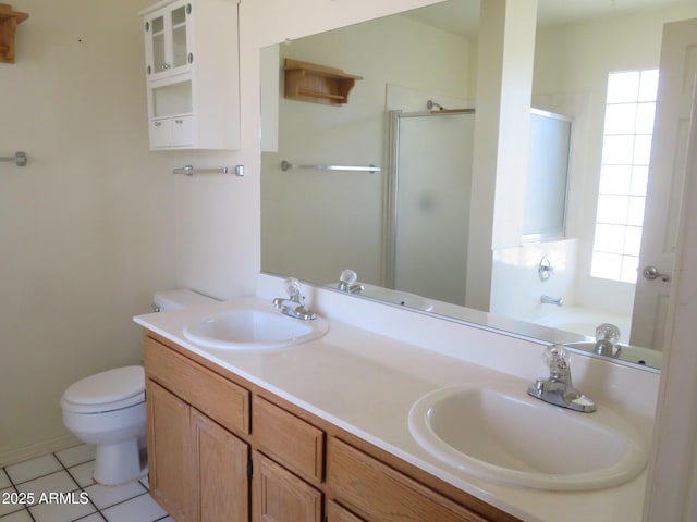 bathroom featuring a shower stall, plenty of natural light, and a sink