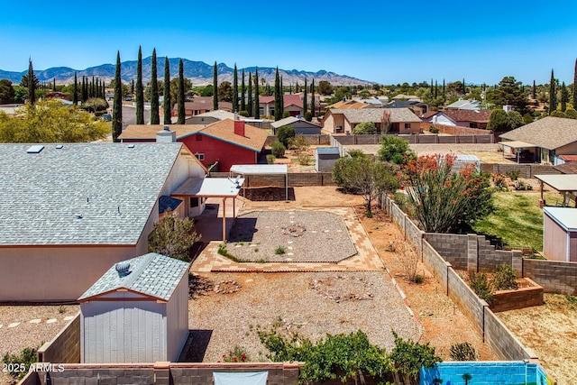 birds eye view of property with a mountain view and a residential view