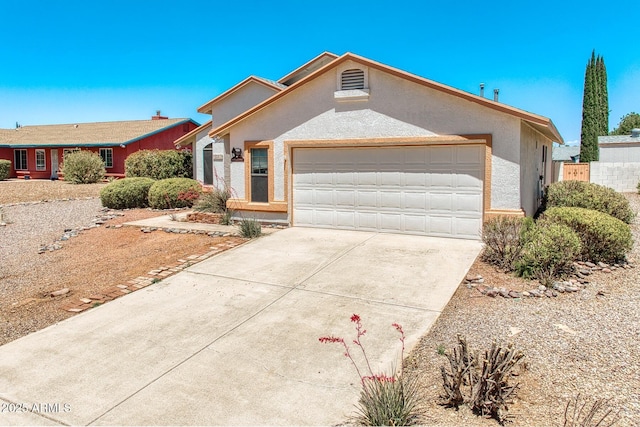single story home featuring a garage, stucco siding, and concrete driveway
