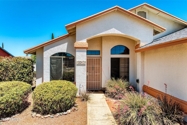 property entrance with stucco siding