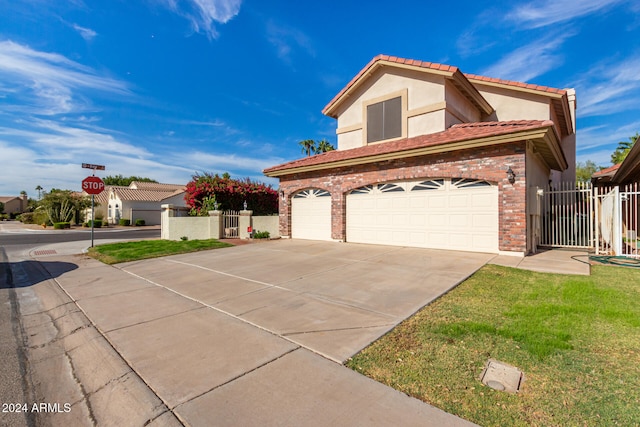 view of front of home featuring a garage and a front yard