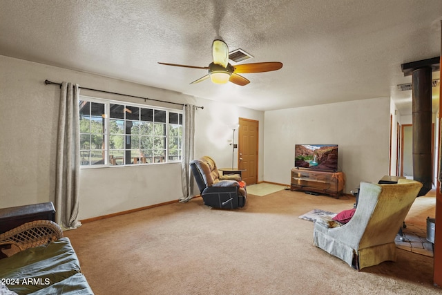 sitting room featuring light colored carpet, a textured ceiling, and ceiling fan