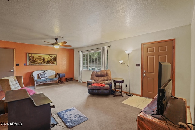 living room with ceiling fan, a textured ceiling, and light carpet