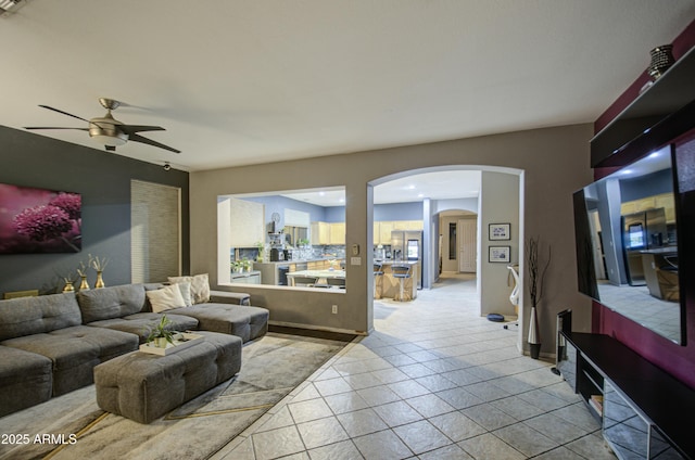 tiled living room featuring ceiling fan