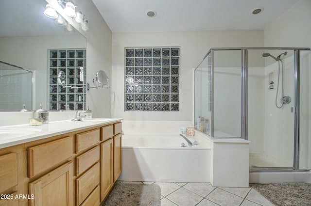 bathroom with vanity, shower with separate bathtub, and tile patterned flooring