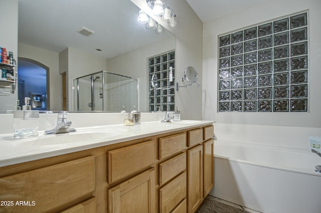 bathroom featuring independent shower and bath and vanity