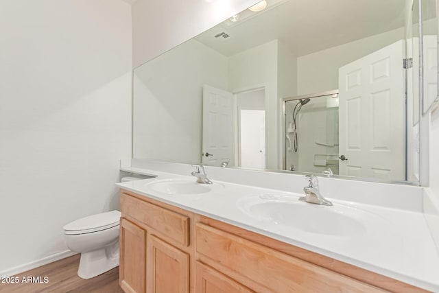 2140 S Benton Cir, Mesa, AZ 85209 - bathroom with toilet, a shower with door, wood finished floors, and double vanity