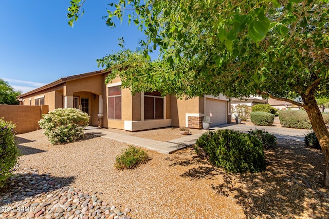 2140 S Benton Cir, Mesa, AZ 85209 - view of front of house featuring stucco siding, fence, concrete driveway, and an attached garage