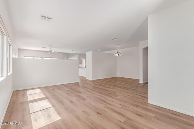 2140 S Benton Cir, Mesa, AZ 85209 - spare room with ceiling fan, light wood-type flooring, arched walkways, and baseboards