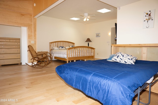 bedroom with ceiling fan and light hardwood / wood-style floors