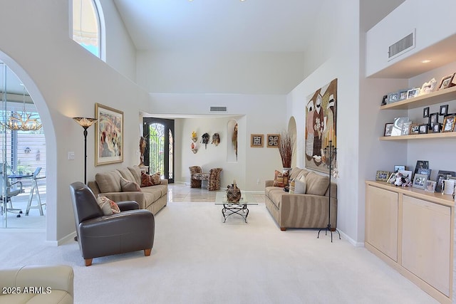 10068 E Cinnabar Ave, Scottsdale, AZ 85258 - living room featuring light colored carpet, visible vents, and arched walkways