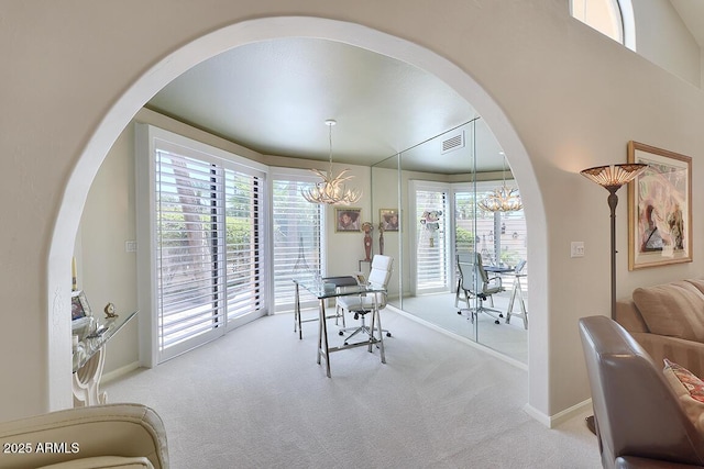 10068 E Cinnabar Ave, Scottsdale, AZ 85258 - carpeted dining room featuring arched walkways, baseboards, visible vents, and a notable chandelier