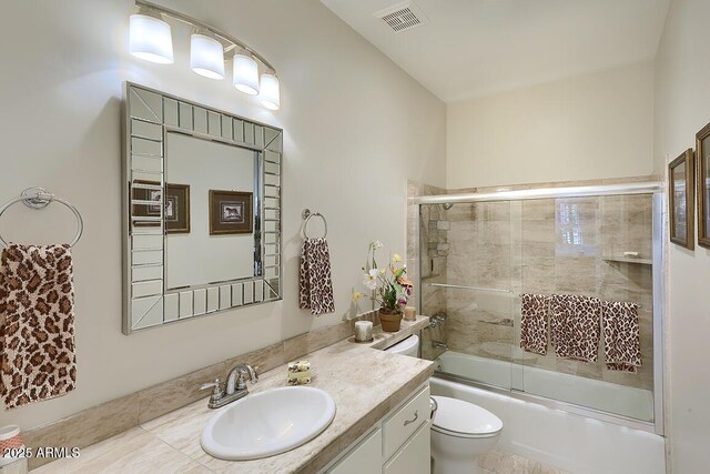 10068 E Cinnabar Ave, Scottsdale, AZ 85258 - full bathroom featuring visible vents, bath / shower combo with glass door, toilet, and vanity
