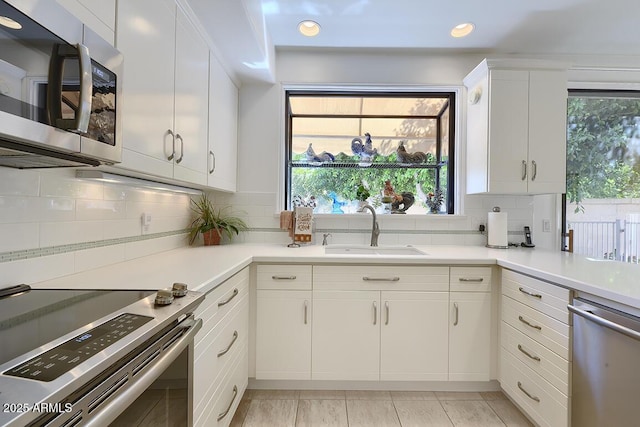 10068 E Cinnabar Ave, Scottsdale, AZ 85258 - kitchen featuring light countertops, a sink, tasteful backsplash, and appliances with stainless steel finishes