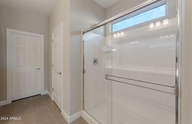 bathroom with tile patterned floors and walk in shower